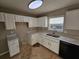 Kitchen with white cabinets, quartz countertops, and tile floors at 2718 High Tide Dr, South Fulton, GA 30349