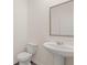 Small powder room with pedestal sink and toilet at 2781 Honey Locust Ct, Loganville, GA 30052