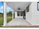 Rear patio featuring recessed lighting, fan, with brick accent and well maintained yard at 515 Pearl St, Cumming, GA 30040