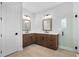 Spacious bathroom featuring double vanities, tiled floor, frameless shower and wood cabinets at 515 Pearl St, Cumming, GA 30040