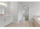 Elegant bathroom with white cabinets, a soaking tub, and a walk-in shower at 515 Pearl St, Cumming, GA 30040