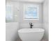 Modern bathroom featuring a soaking tub and glass-enclosed shower at 515 Pearl St, Cumming, GA 30040