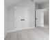 Bright bedroom with neutral walls and carpet flooring, featuring double doors at 515 Pearl St, Cumming, GA 30040