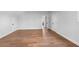 Large bonus room with hardwood flooring, neutral walls, and multiple doors at 515 Pearl St, Cumming, GA 30040