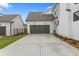 Two-car garage with gray doors and long driveway at 515 Pearl St, Cumming, GA 30040