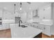 Island kitchen with white cabinets and stainless steel appliances at 515 Pearl St, Cumming, GA 30040