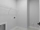 Functional laundry room with overhead shelving and built-in utility space at 515 Pearl St, Cumming, GA 30040