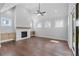 Bright living room with a fireplace, hardwood floors, a vaulted ceiling, a ceiling fan, and lots of natural light at 515 Pearl St, Cumming, GA 30040