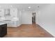 Open-concept living room featuring hardwood floors and leading into the kitchen with modern stainless steel appliances at 515 Pearl St, Cumming, GA 30040