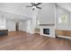 Large living room with a fireplace, hardwood floors, built-in cabinets, a kitchen, a door, and natural light at 515 Pearl St, Cumming, GA 30040