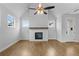 Spacious living area featuring hardwood floors, a fireplace, and large windows at 515 Pearl St, Cumming, GA 30040
