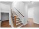 Staircase with wood treads, wooden handrail and black metal spindles at 515 Pearl St, Cumming, GA 30040