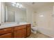 Bathroom with a wood vanity, a large mirror, and a tub-shower combo at 1656 Hedington Ct, Lawrenceville, GA 30045