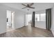 Bright bedroom with wood-look floors, ceiling fan, and access to bathroom at 346 Carpenter Dr # 51, Atlanta, GA 30328