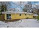 Snow-covered backyard with yellow house and patio at 3211 Sandusky Dr, Decatur, GA 30032