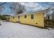 Side yard view of yellow house with snow on the ground at 3211 Sandusky Dr, Decatur, GA 30032