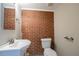 Basement bathroom with updated vanity and exposed brick at 3211 Sandusky Dr, Decatur, GA 30032