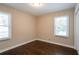 Bedroom with hardwood floors and two windows at 3211 Sandusky Dr, Decatur, GA 30032