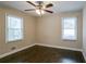 Bedroom with hardwood floors, ceiling fan, and two windows at 3211 Sandusky Dr, Decatur, GA 30032