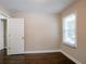 Bedroom with hardwood floors, window, and door to hallway at 3211 Sandusky Dr, Decatur, GA 30032