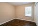 Bedroom with hardwood floors, window, and neutral walls at 3211 Sandusky Dr, Decatur, GA 30032
