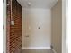 Basement laundry area with tile floors and brick wall at 3211 Sandusky Dr, Decatur, GA 30032