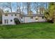 Large backyard with lush green lawn and white home at 3048 Charlbury Pl, Avondale Estates, GA 30002