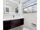 Modern bathroom with marble tile, floating vanity, and large mirror at 3048 Charlbury Pl, Avondale Estates, GA 30002