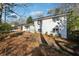 White brick home with large windows and mature trees at 3048 Charlbury Pl, Avondale Estates, GA 30002