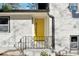 Inviting yellow front door entryway with black railing at 3048 Charlbury Pl, Avondale Estates, GA 30002