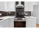 Modern kitchen with dark-tile backsplash and stainless steel appliances at 3048 Charlbury Pl, Avondale Estates, GA 30002