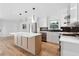 Modern kitchen with island, quartz countertops and dark tile backsplash at 3048 Charlbury Pl, Avondale Estates, GA 30002