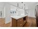 Modern kitchen with island, stainless steel appliances, and hardwood floors at 3048 Charlbury Pl, Avondale Estates, GA 30002
