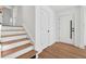 Bright entryway with hardwood floors and staircase leading upstairs at 3048 Charlbury Pl, Avondale Estates, GA 30002