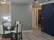 Dining area with glass table and four chairs, next to a navy blue accent wall at 1336 Diamond Se Ave, Atlanta, GA 30316