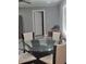 Dining area with a glass-top table and four off-white chairs at 1336 Diamond Se Ave, Atlanta, GA 30316
