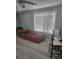 Living room with rust colored couch and wood-look floors at 1336 Diamond Se Ave, Atlanta, GA 30316