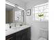 Bathroom boasts a dark vanity, quartz countertop, and a sleek frameless mirror at 2233 Troutdale Dr, Decatur, GA 30032