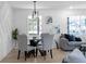 Bright dining area with glass table and gray chairs, an accent wall, and hardwood floors at 2233 Troutdale Dr, Decatur, GA 30032
