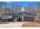 Newly renovated ranch home with gray garage door and landscaped yard at 2233 Troutdale Dr, Decatur, GA 30032