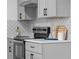 Modern kitchen features gray cabinets, herringbone backsplash, and stainless steel appliances at 2233 Troutdale Dr, Decatur, GA 30032
