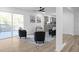Living area with black armchairs, hardwood floors, and a view of the kitchen and deck at 2233 Troutdale Dr, Decatur, GA 30032