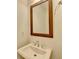 Small bathroom with white sink and wood framed mirror at 3528 Myron Pl, Suwanee, GA 30024