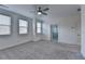 Spacious main bedroom with grey carpet, ceiling fan, and en-suite bathroom at 3528 Myron Pl, Suwanee, GA 30024