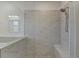 Large walk-in shower with marble tile and built-in seat at 3528 Myron Pl, Suwanee, GA 30024