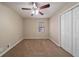 Bright bedroom with ceiling fan, carpet, and double door closet at 4424 Malibu Dr, Decatur, GA 30035