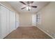 Bedroom with ceiling fan, carpet, and double door closet at 4424 Malibu Dr, Decatur, GA 30035