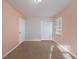 Bright bedroom featuring neutral walls, carpet, and double closet at 4424 Malibu Dr, Decatur, GA 30035