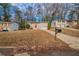 Ranch style home with red door, attached garage, and a large yard at 4424 Malibu Dr, Decatur, GA 30035