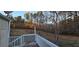 Wooden deck overlooking wooded area with white railings at 710 Seals Rd, Dallas, GA 30157